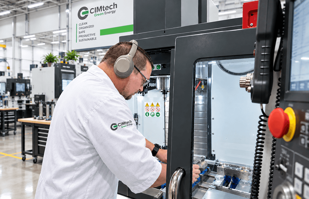 CIMtech Green Energy operator at a CNC machine on the manufacturing floor